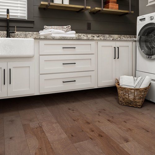 Kitchen with a basket of laundry on hardwood flooring from C G Interiors in San Leandro, CA