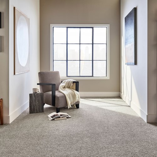 Gray armchair next to a window in a room with gray carpet from C G Interiors in San Leandro, CA