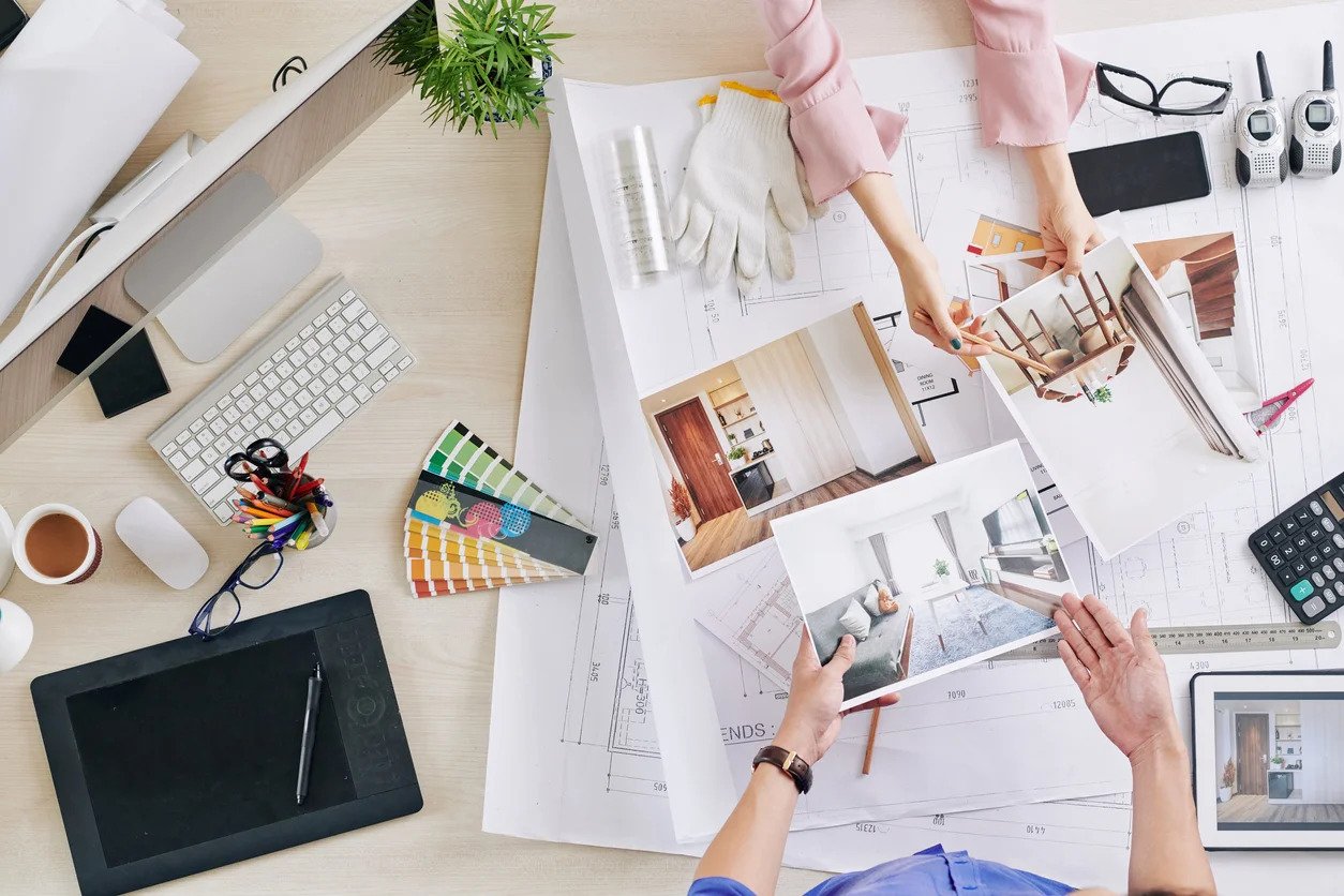 people looking at designs on a desk - Interior design consultation by our experts at C G Interiors in San Leandro, CA