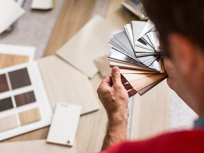 Person looking at different tiles from C G Interiors in San Leandro, CA
