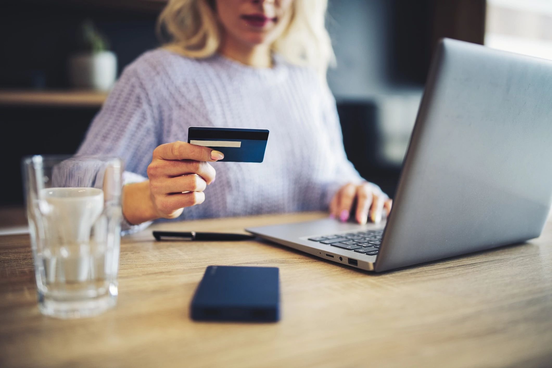 person using laptop to pay by card online at C G Interiors in San Leandro, CA