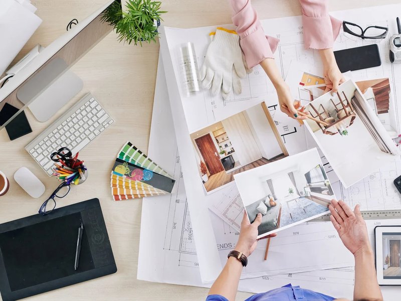 people looking at designs on a desk - Interior design consultation by our experts at C G Interiors in San Leandro, CA