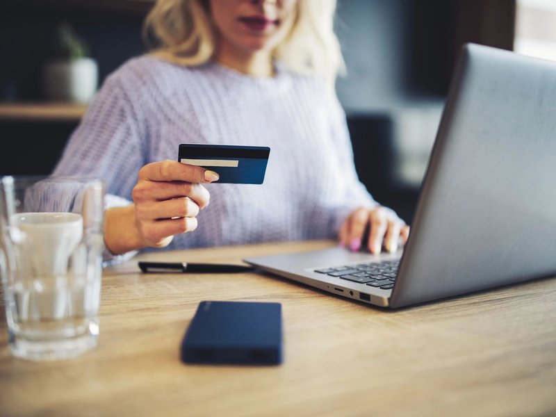 person using laptop to pay by card online at C G Interiors in San Leandro, CA