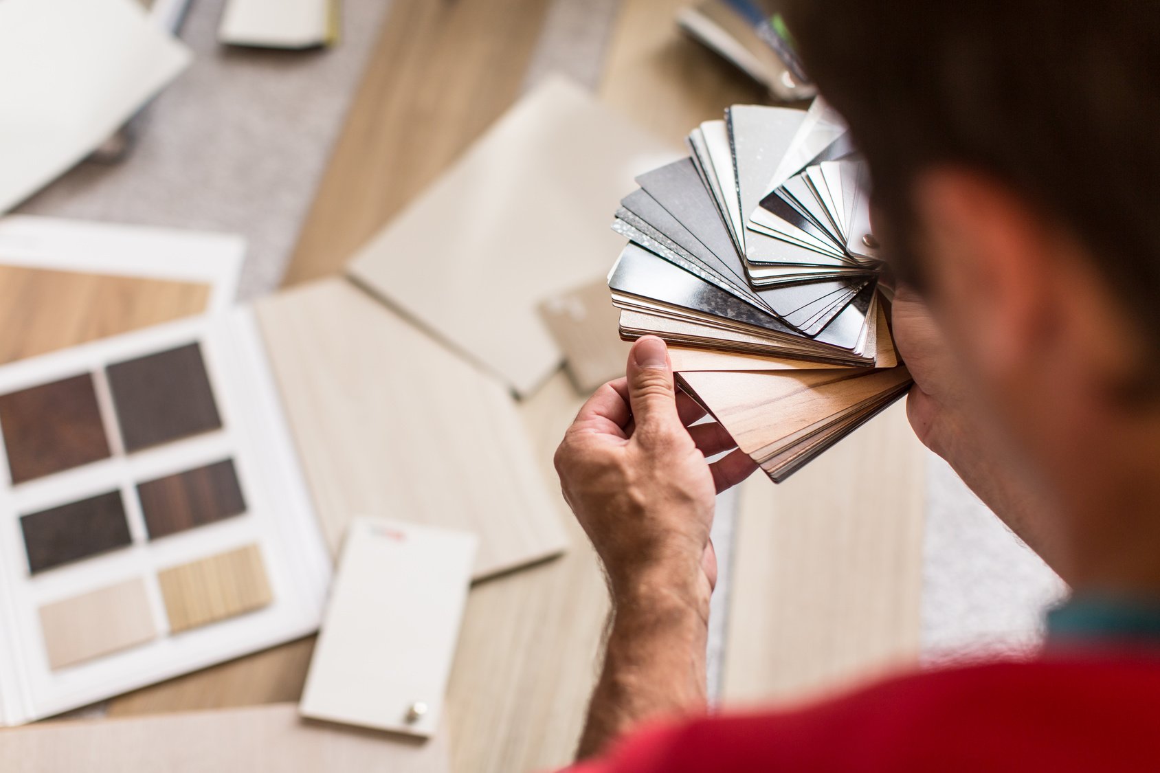 Person looking at different tiles from C G Interiors in San Leandro, CA