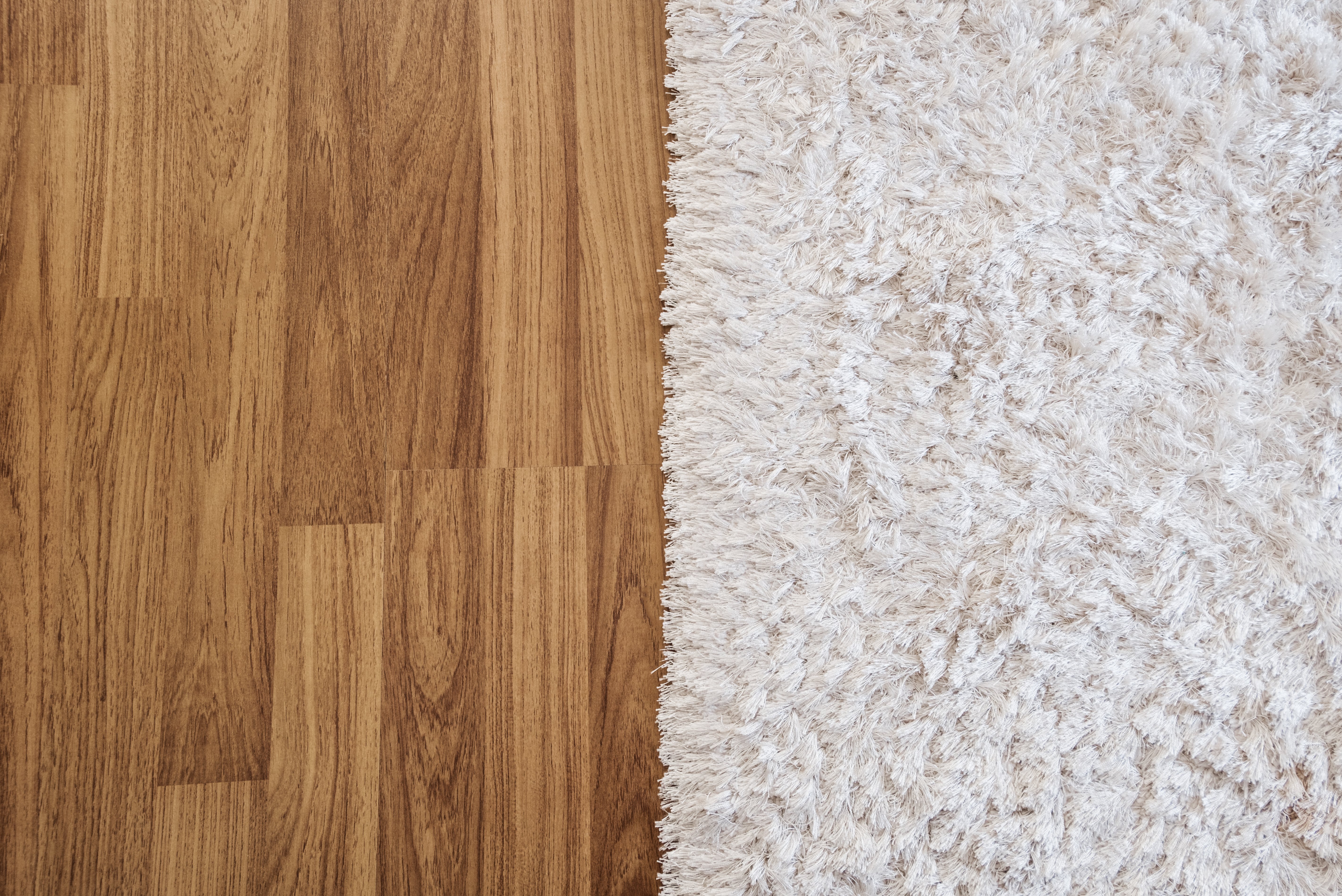 White rug on hardwood flooring - Carpet binding services from C G Interiors in San Leandro, CA